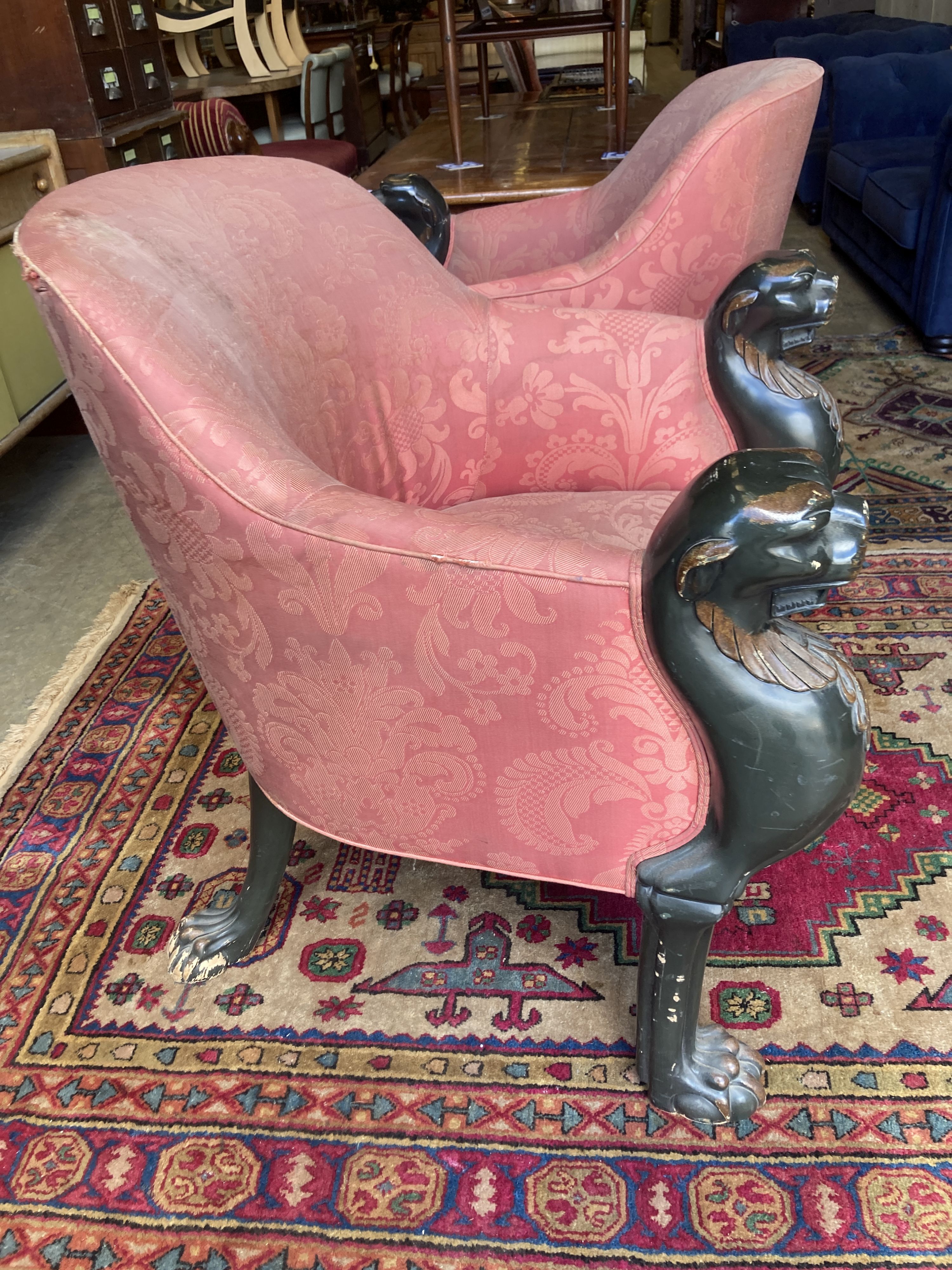 A pair of Empire style upholstered armchairs in the manner of Thomas Hope with leopards head terminals, width 80cm, depth 80cm, height